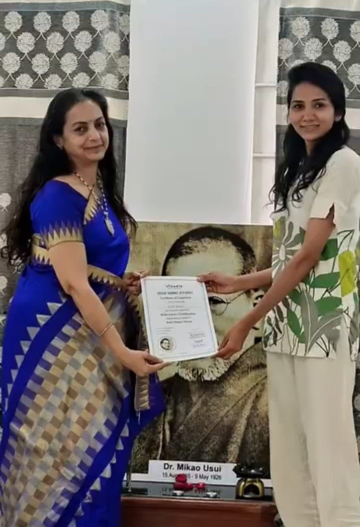Asma Begum receiving an excellence award for yoga and wellness coaching
