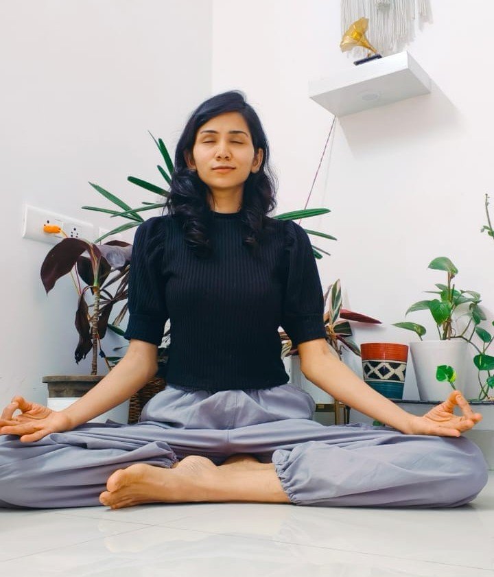 Asma Begum practicing meditation during a yoga session