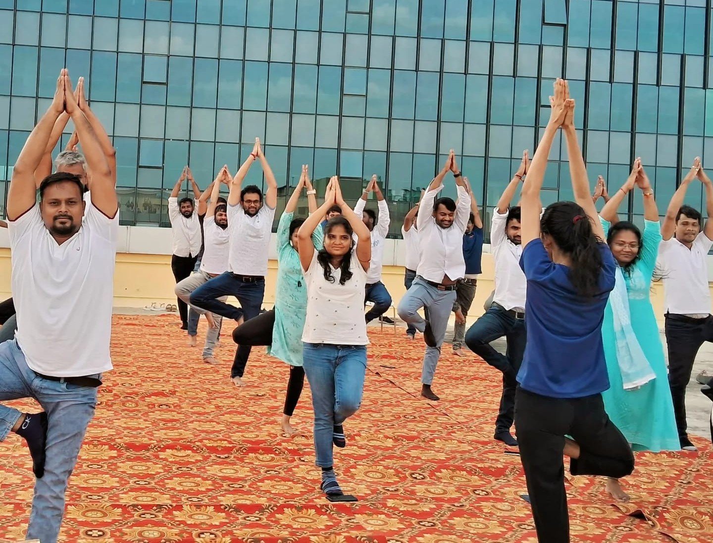 Participants practicing Tree Pose during a group yoga session by Asma Fitness